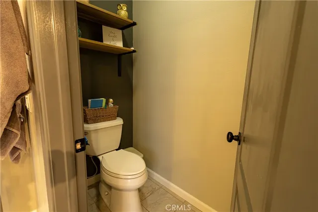a white toilet sitting next to a shower curtain
