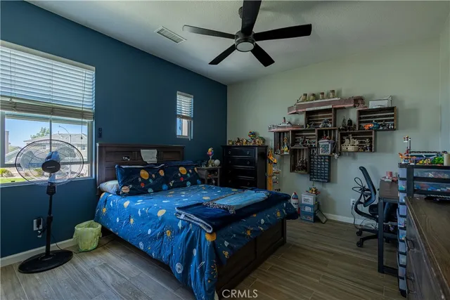 a bedroom with a bed and wooden floor
