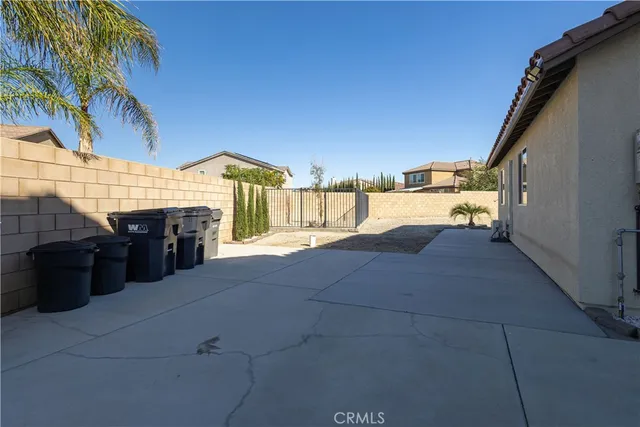 a view of roof deck with couches and potted plants