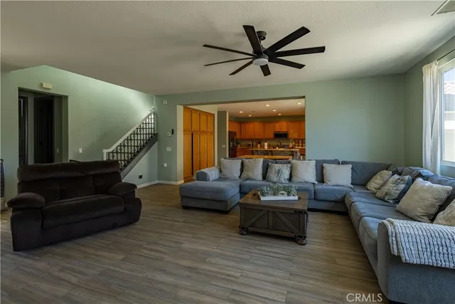a living room with furniture and a flat screen tv with wooden floor