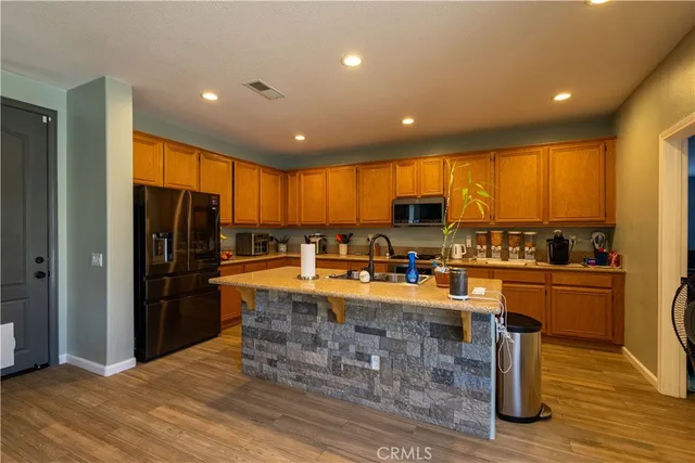 a large kitchen with lots of counter space cabinets and appliances