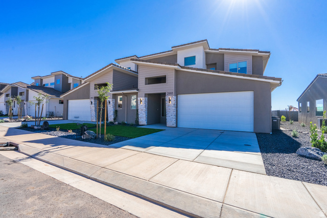2972 West 570 North Hurricane, UT 84737 - Photo 5 of 104 View of front facade featuring driveway, stucco siding, and stone siding