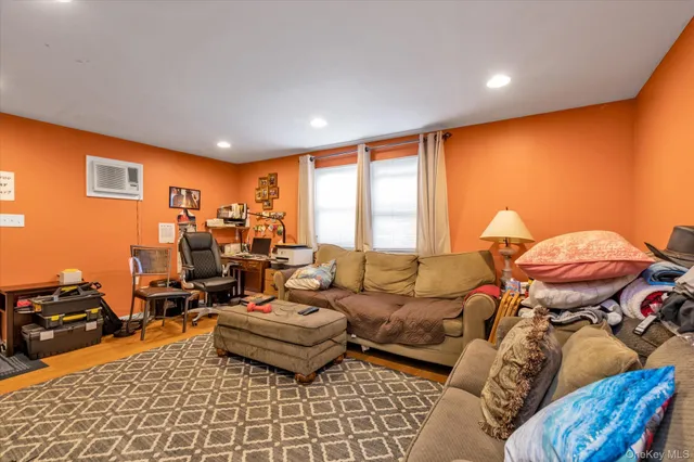 a living room with furniture and a gym equipment