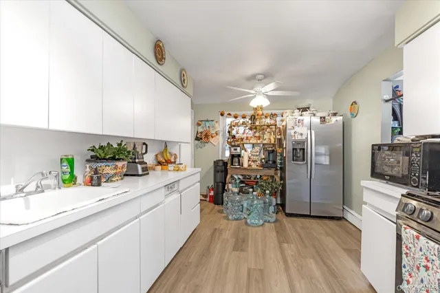 a kitchen with granite countertop a refrigerator and a sink