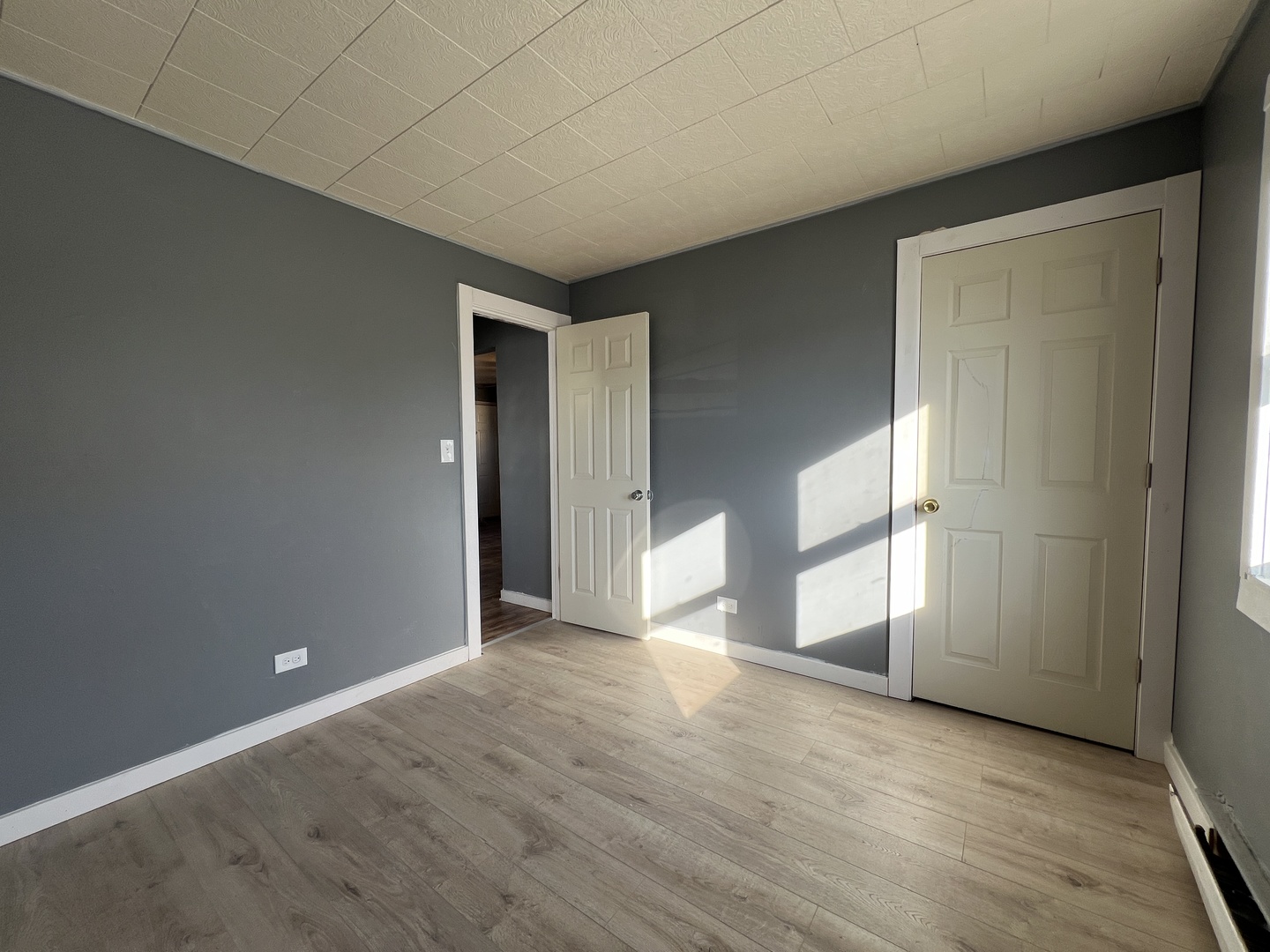 5305 South 72nd Court, Unit 4 Summit, IL 60501 - Photo 11 of 17 an empty room with wooden floor and windows