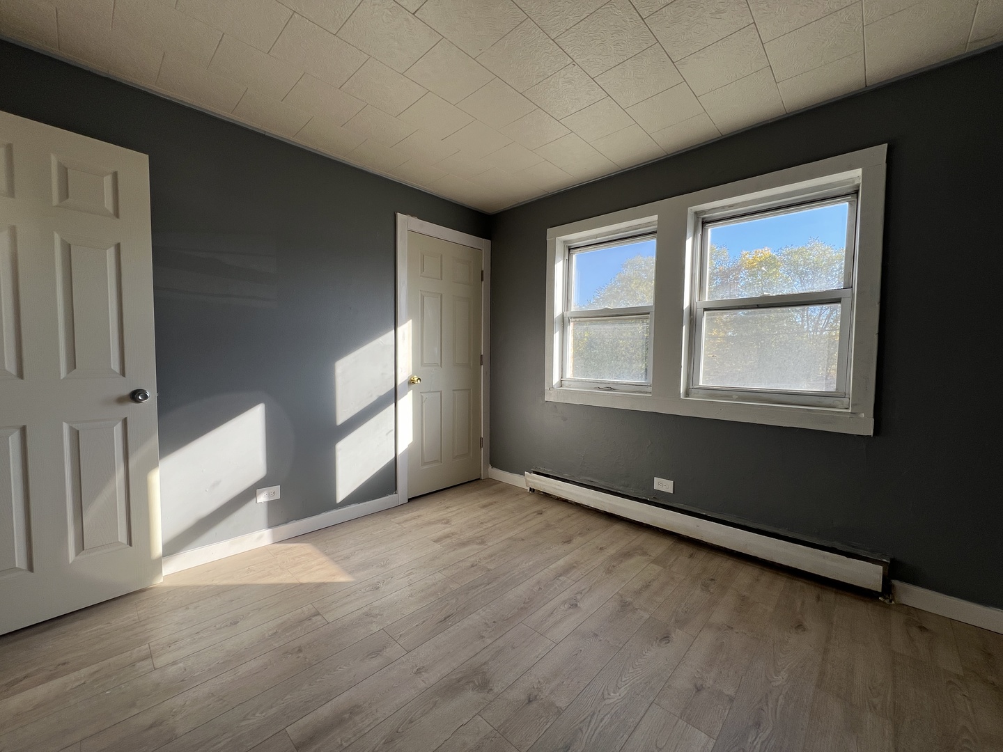 5305 South 72nd Court, Unit 4 Summit, IL 60501 - Photo 12 of 17 an empty room with wooden floor and windows