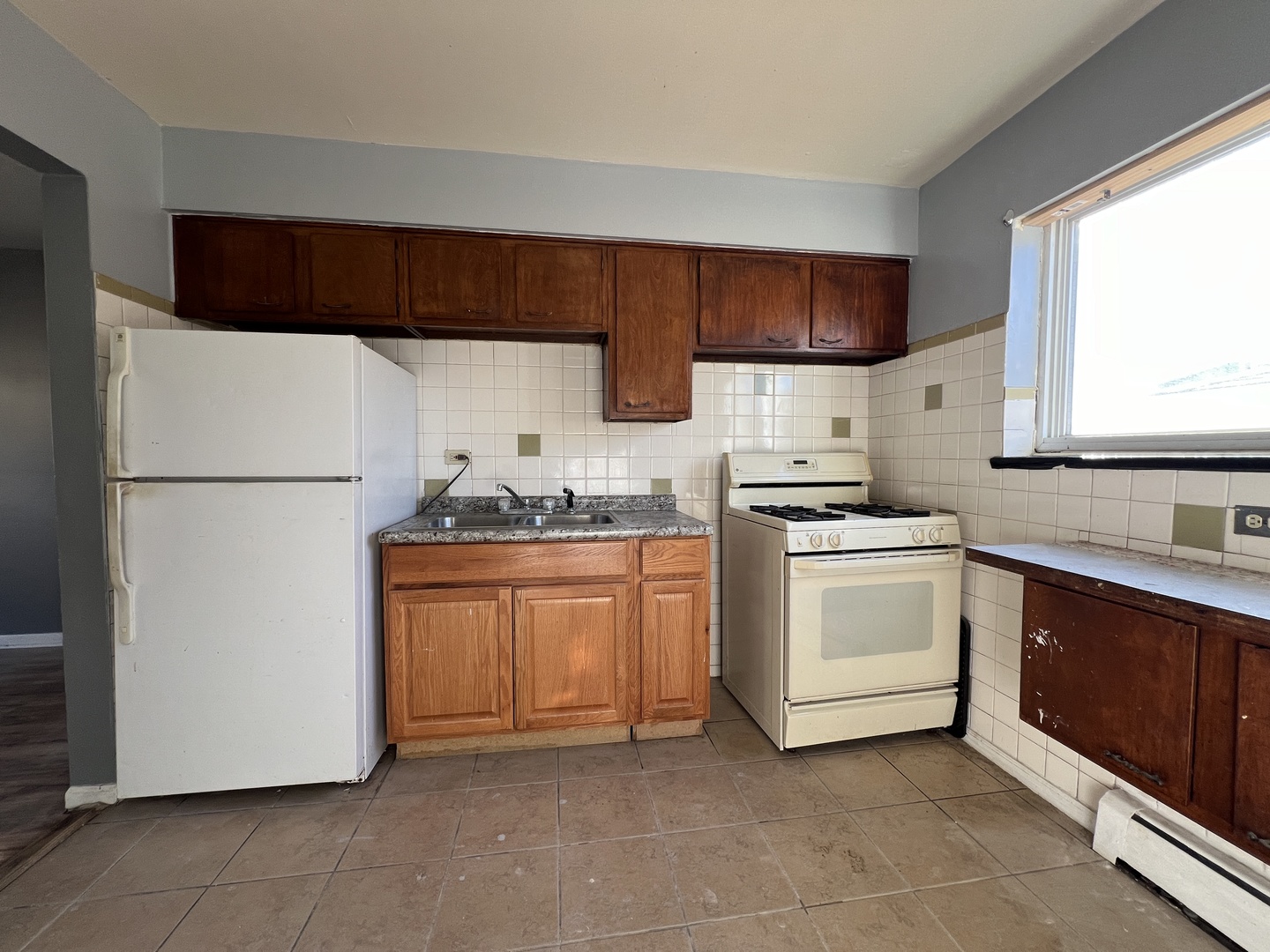 5305 South 72nd Court, Unit 4 Summit, IL 60501 - Photo 13 of 17 a kitchen with stainless steel appliances a refrigerator sink and cabinets