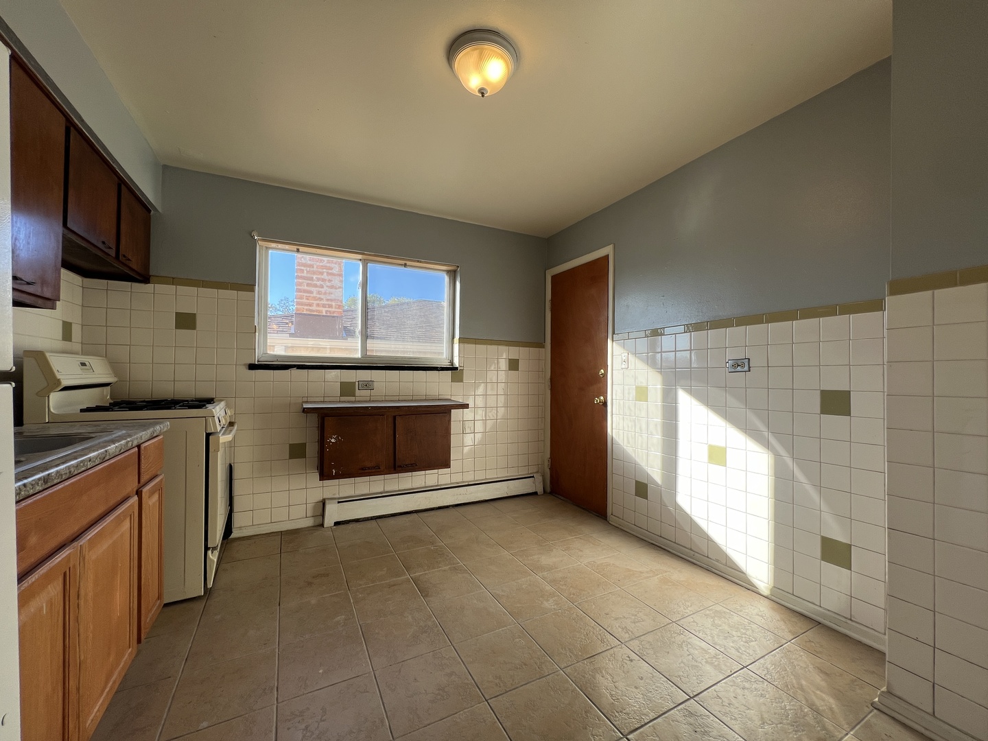 5305 South 72nd Court, Unit 4 Summit, IL 60501 - Photo 14 of 17 a kitchen with stainless steel appliances granite countertop a stove a sink and a microwave