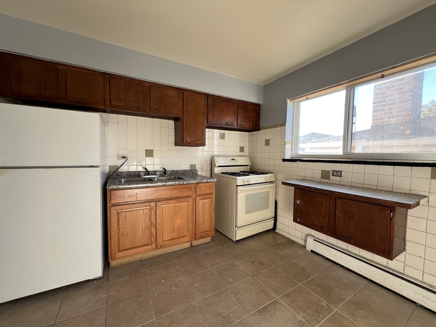 5305 South 72nd Court, Unit 4 Summit, IL 60501 - Photo 15 of 17 a kitchen with white cabinets and white appliances