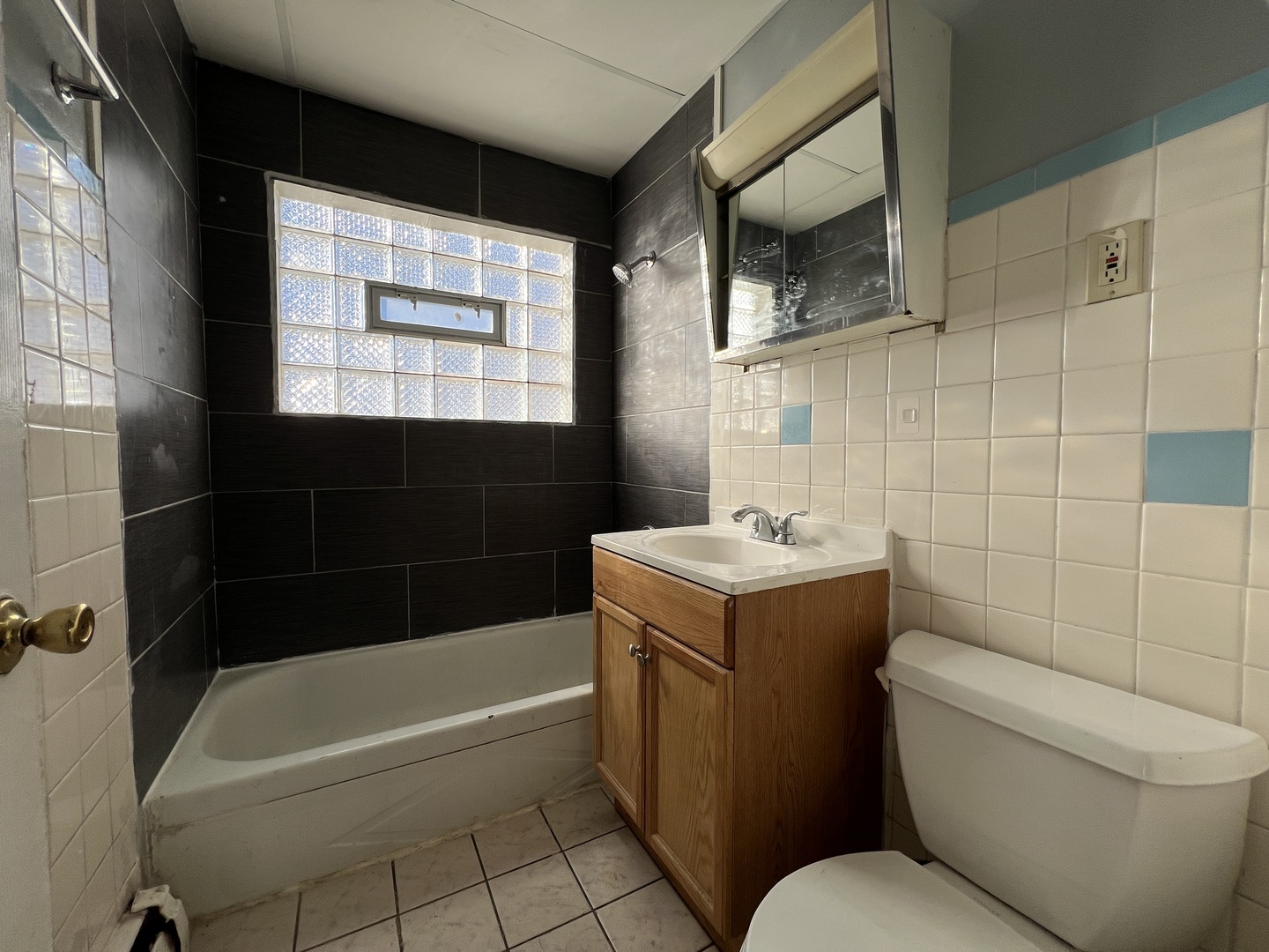 5305 South 72nd Court, Unit 4 Summit, IL 60501 - Photo 16 of 17 a bathroom with a sink a toilet and bathtub