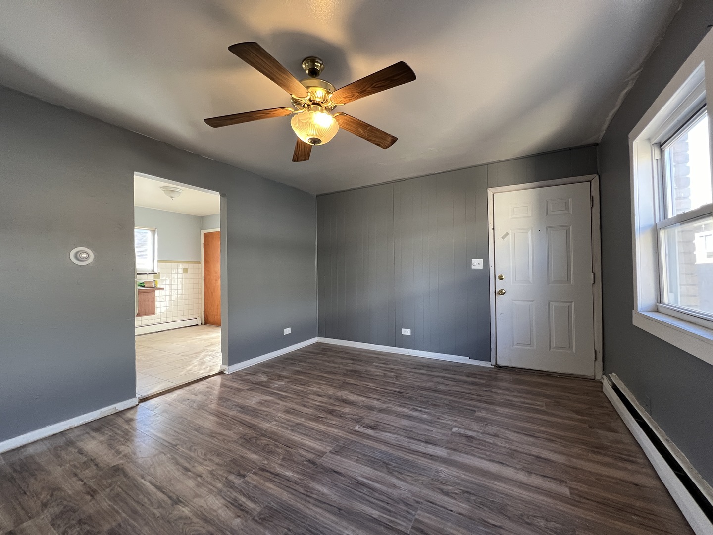 5305 South 72nd Court, Unit 4 Summit, IL 60501 - Photo 4 of 17 a view of an empty room with wooden floor and a window