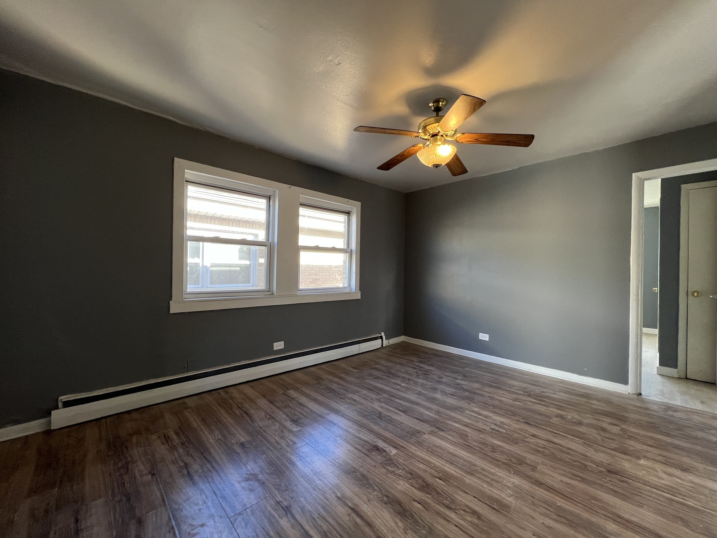 5305 South 72nd Court, Unit 4 Summit, IL 60501 - Photo 5 of 17 a view of an empty room with window and wooden floor