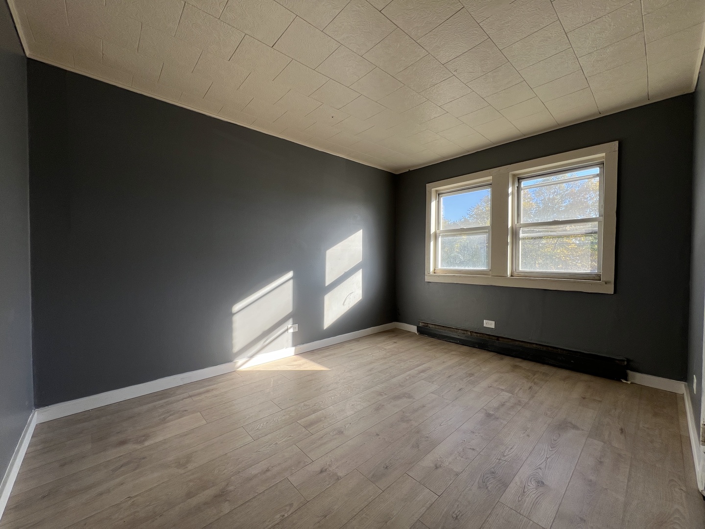 5305 South 72nd Court, Unit 4 Summit, IL 60501 - Photo 7 of 17 a view of an empty room with a window and wooden floor