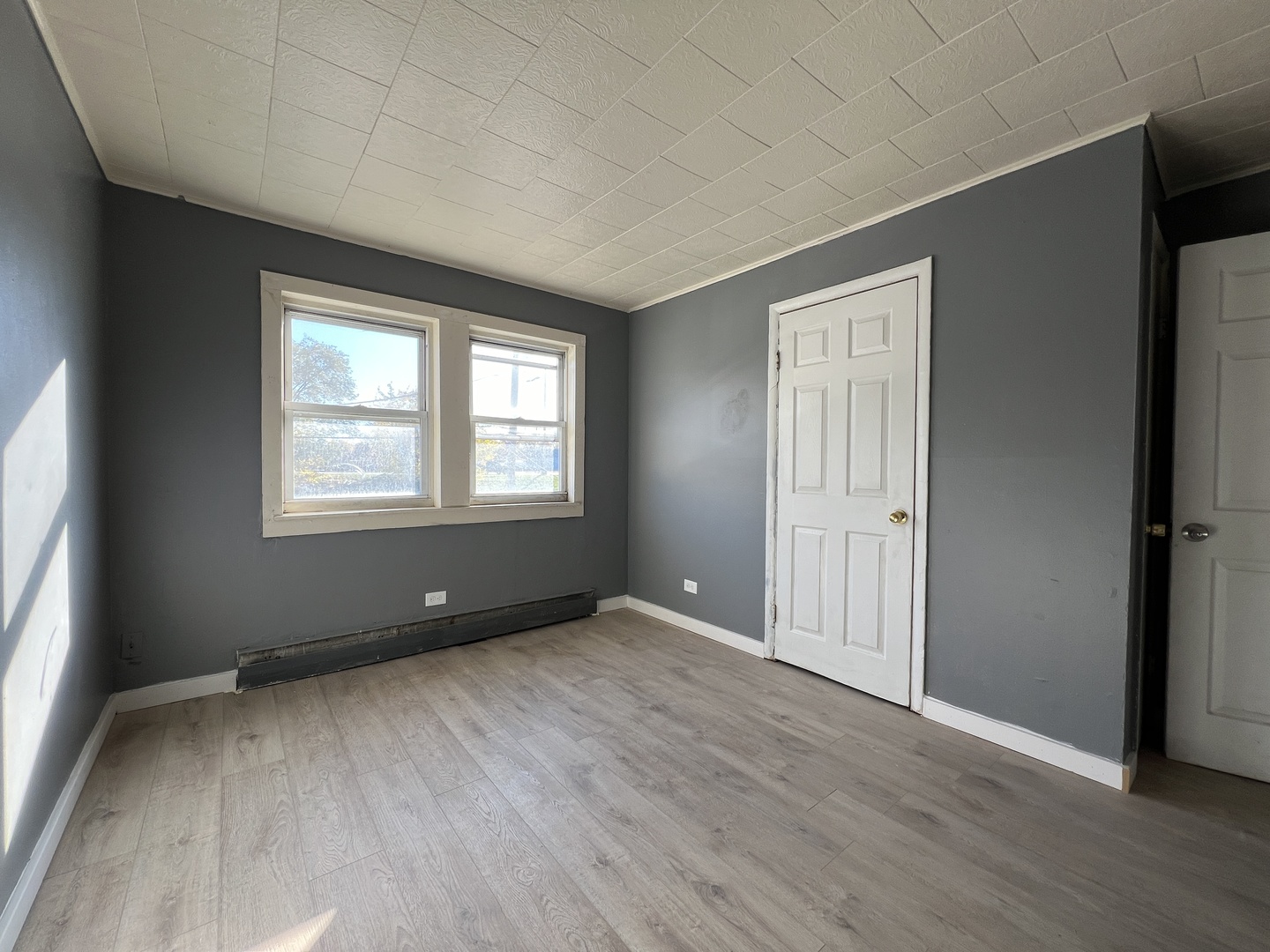 5305 South 72nd Court, Unit 4 Summit, IL 60501 - Photo 8 of 17 an empty room with wooden floor and windows