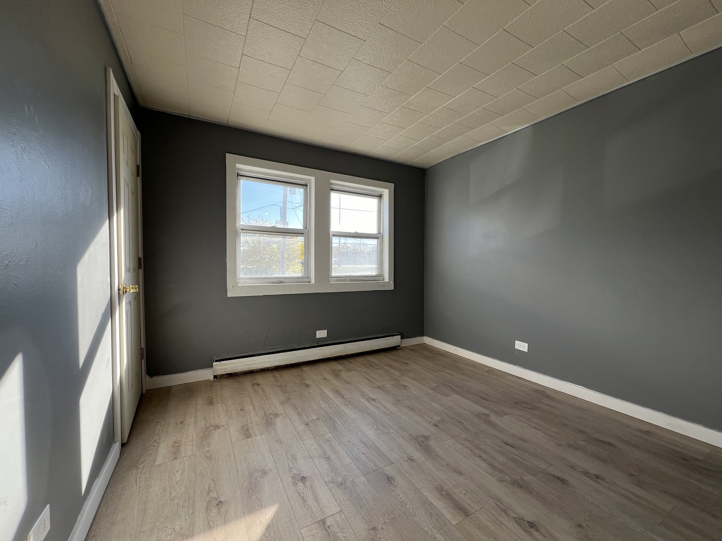 5305 South 72nd Court, Unit 4 Summit, IL 60501 - Photo 10 of 17 an empty room with wooden floor and windows