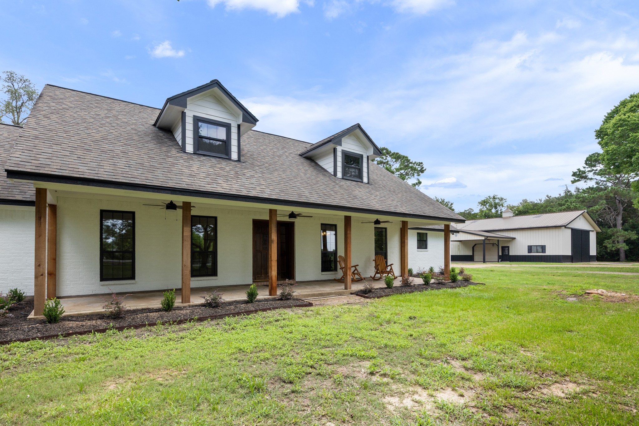 10209 Oberrender Road Needville, TX 77461 - Photo 5 of 50 Brand New Cedar Post, Freshly Painted Exterior, welcoming covered front porch, and updated Landscaping add to the handsome curb appeal.