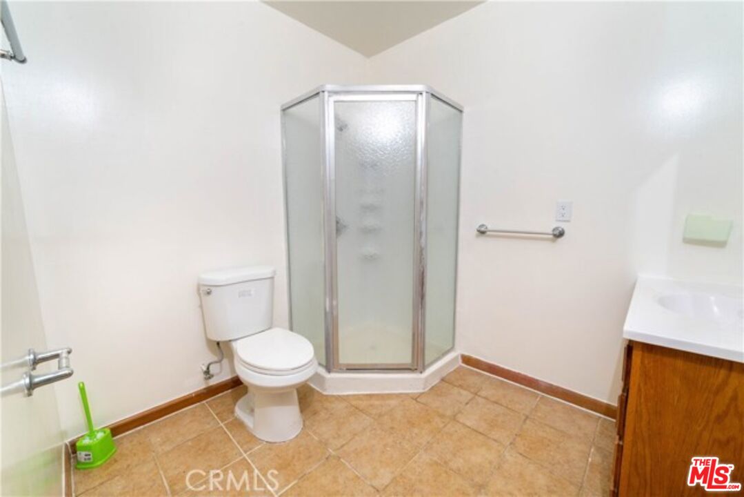 1023 South Wilton Place Los Angeles, CA 90019 - Photo 23 of 34 a bathroom with a toilet and a sink