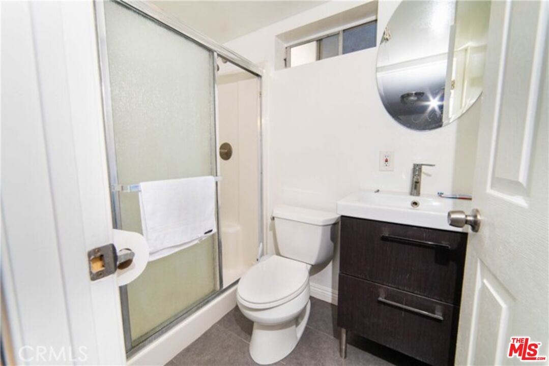 1023 South Wilton Place Los Angeles, CA 90019 - Photo 30 of 34 a bathroom with a sink toilet and shower