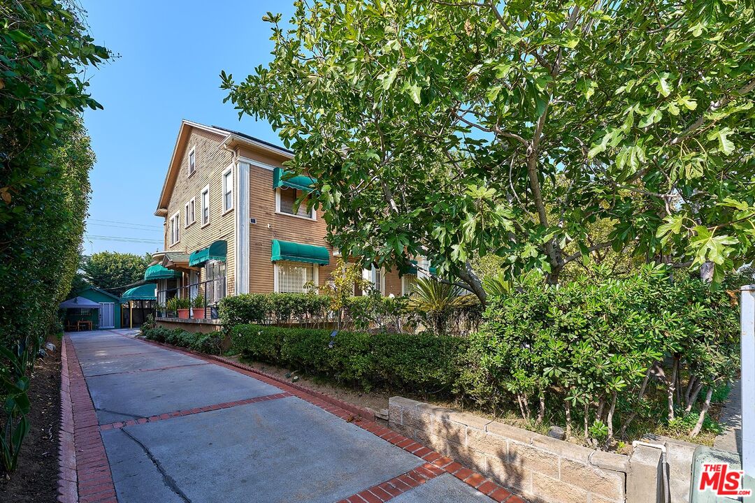 1023 South Wilton Place Los Angeles, CA 90019 - Photo 5 of 34 a front view of a house with a yard