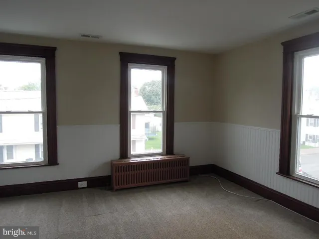 a view of an empty room and a window