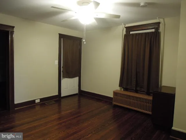 an empty room with wooden floor and closet