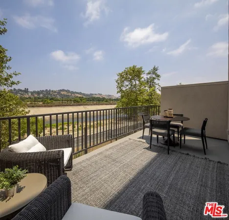 a terrace with outdoor seating and city view