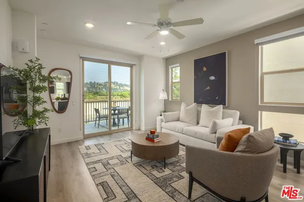 a living room with furniture and a large window