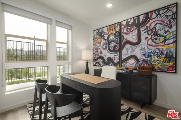 a view of a dining room with furniture and a window