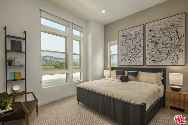 a bedroom with a large bed and a large window