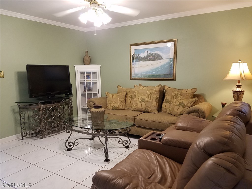 8140 Country Road, Unit 103 Fort Myers, FL 33919 - Photo 2 of 10 a living room with furniture and a flat screen tv