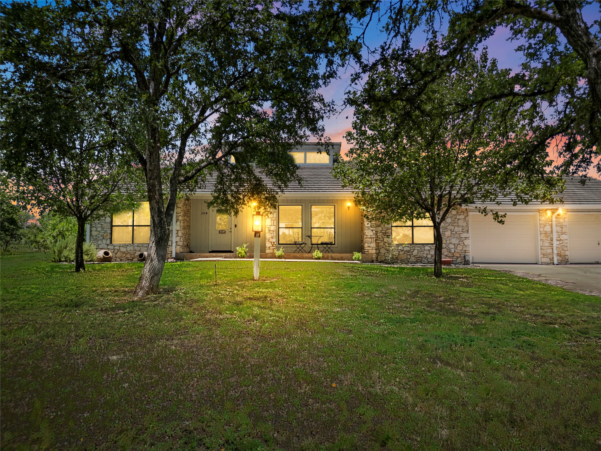 210 Teeoff, Unit B Horseshoe Bay, TX 78657 - Photo 1 of 38 A charming stone facade home nestled amidst mature trees with a convenient attached garage.