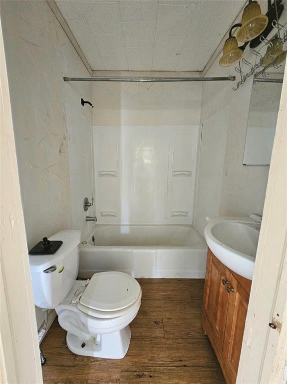 704 2nd Street Bangs, TX 76823 - Photo 8 of 10 a bathroom with a toilet and a bathtub