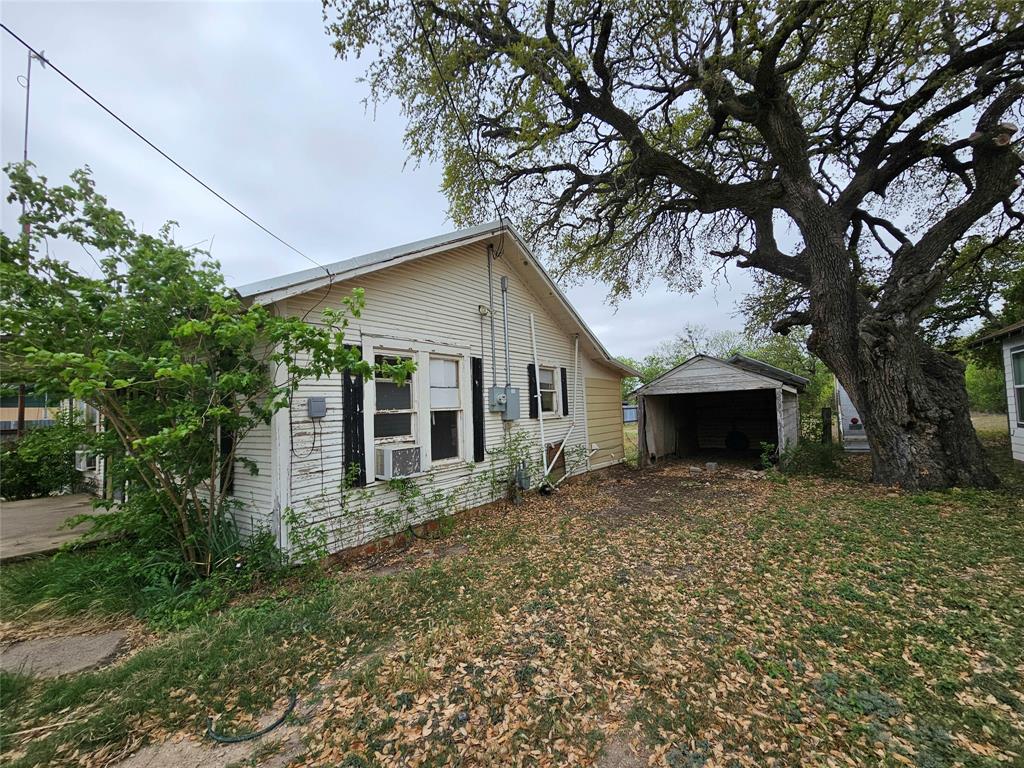 704 2nd Street Bangs, TX 76823 - Photo 9 of 10 a front view of house with yard and trees