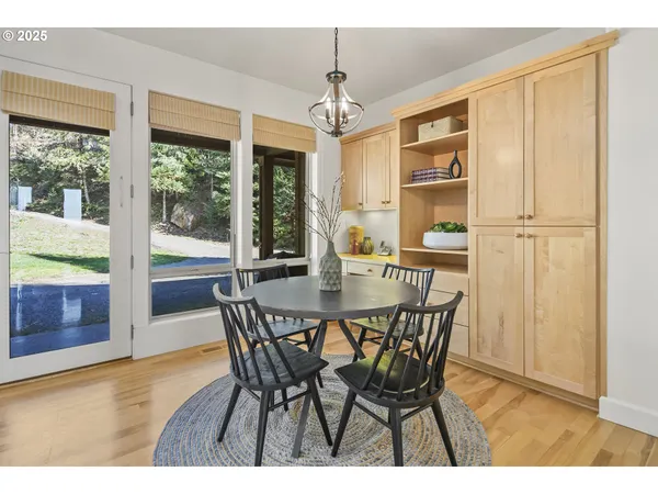 a dining room with furniture window and wooden floor