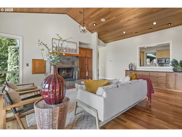 a living room with furniture a fireplace and a table