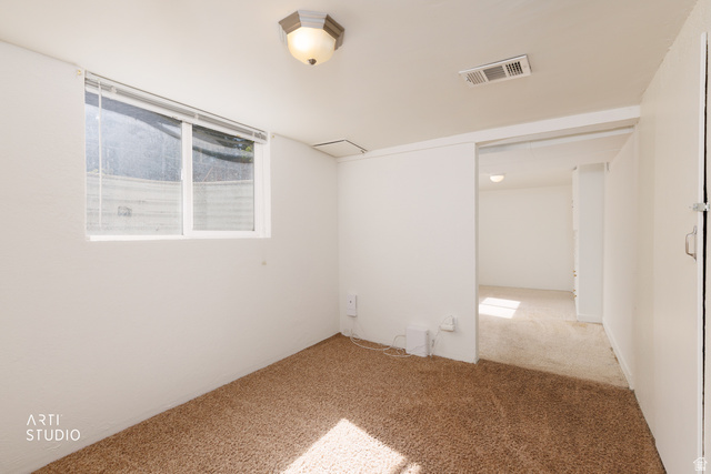 146 West 200 N Street Springville, UT 84663 - Photo 19 of 29 Carpeted room featuring a white-framed window with blinds, ceiling-mounted light fixture, and recessed air vent