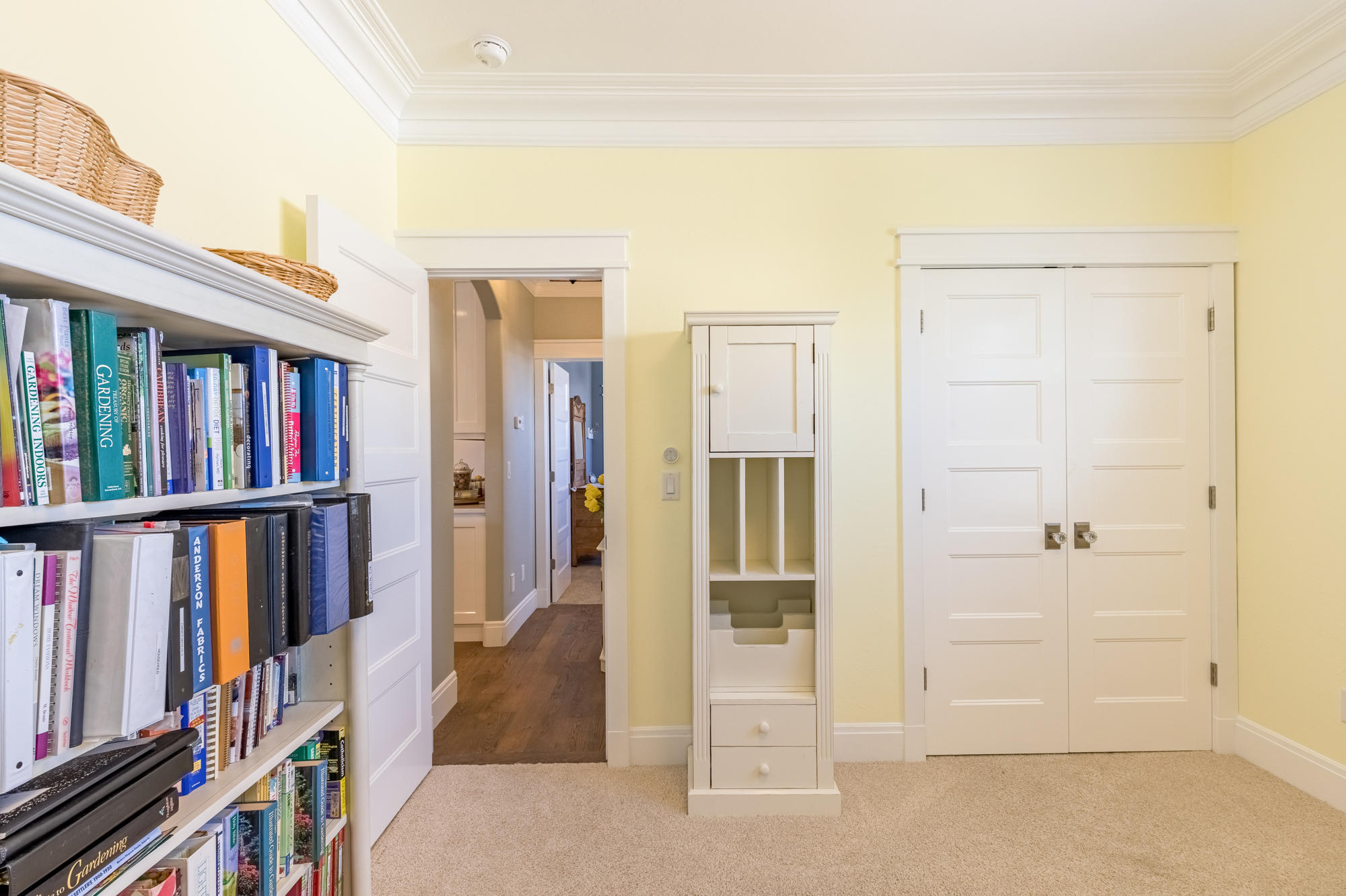 490 Cobble Drive Montrose, CO 81403 - Photo 32 of 58 a view of a bedroom with wooden floor and book shelf