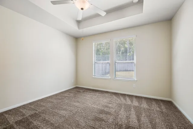 an empty room with a empty space and windows