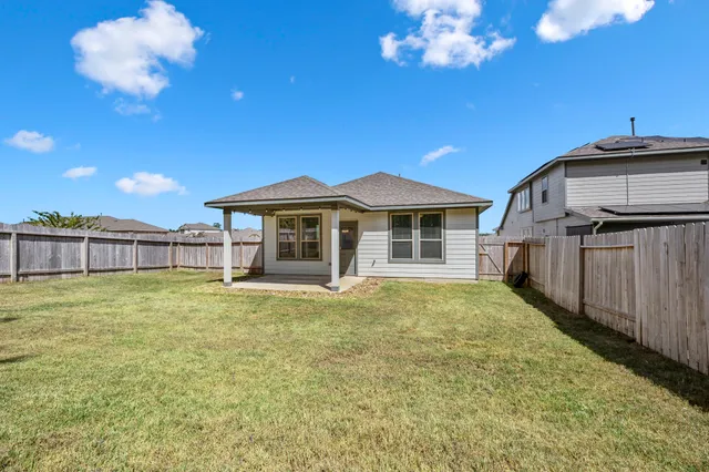 a view of a house with a backyard