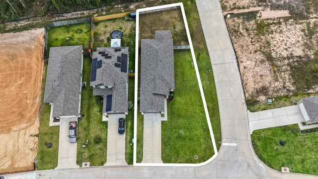 an aerial view of residential houses with outdoor space