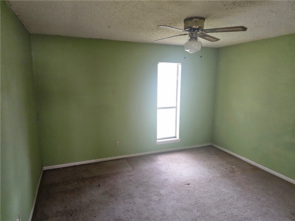 4961 Shadowbend Drive Corpus Christi, TX 78413 - Photo 14 of 16 an empty room with a window and a fan