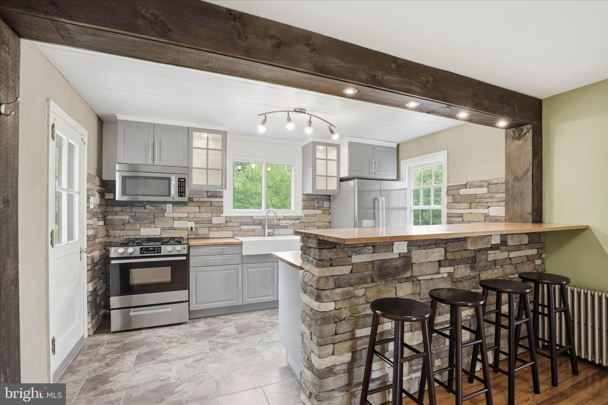 169 School House Road Lancaster, PA 17603 - Photo 12 of 39 a kitchen with kitchen island granite countertop a stove a sink and a refrigerator