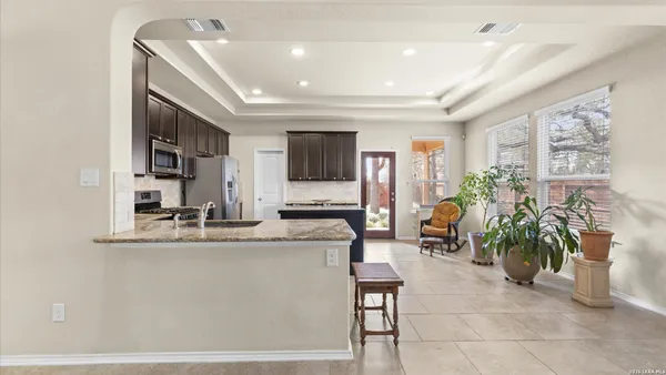 a lobby with furniture potted plant and a large mirror