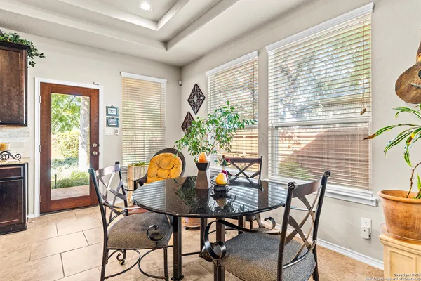 a view of a dining room with furniture and a window