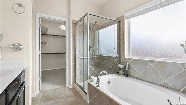 a bathroom with a tub sink and mirror