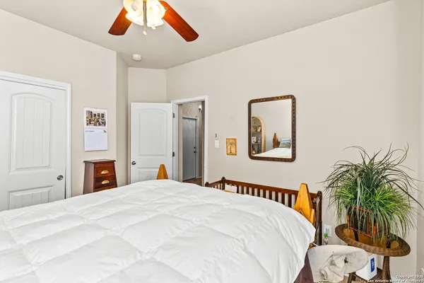 a bedroom with a large bed and a chandelier