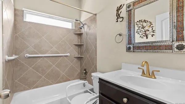 a bathroom with a sink a toilet and shower