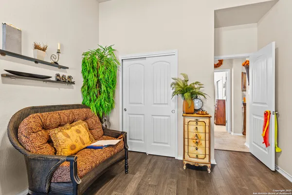 a living room with furniture and a potted plant