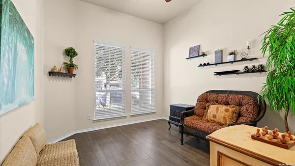 a living room with furniture and a potted plant
