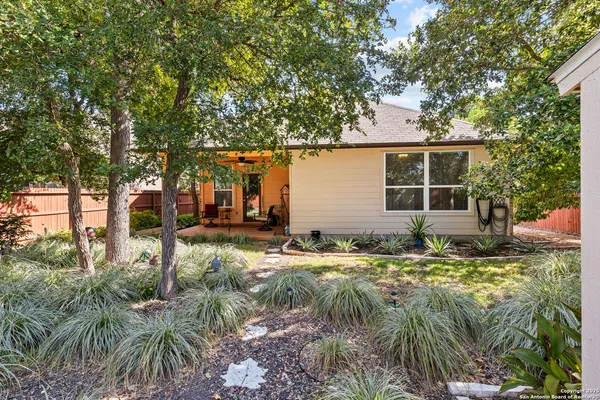 a backyard of a house with yard and outdoor seating